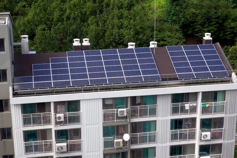 Solar panels installed on the roof of an apartment building