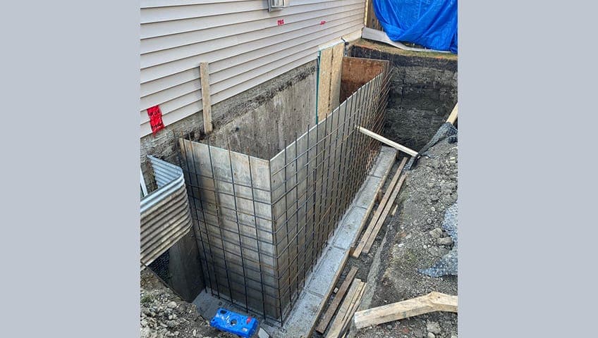 A separate side entrance to a basement suite -- every legal secondary suite in Edmonton must have its own independent entrance that does not pass through the main home