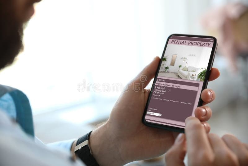 Person searching for apartments on smartphone